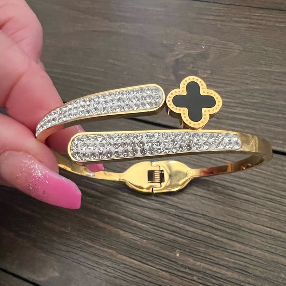 Jewelry - GOLD STAINLESS STEEL BANGLE ACCENTED BLACK FOUR LEAF CLOVER AND CRYSTALS